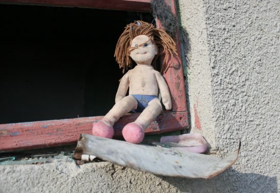An image of a dirty, discarded doll to represent homelessness or abuse